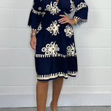 Plus size marine blue v-neck boho summer dress featuring floral embroidery, shown on a model. The dress is a one-piece garment with short sleeves.