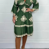 
A plus size dark green V-neck boho summer dress with floral embroidery, shown in size 3XL. The dress is a one-piece garment with short sleeves and falls to the knees.