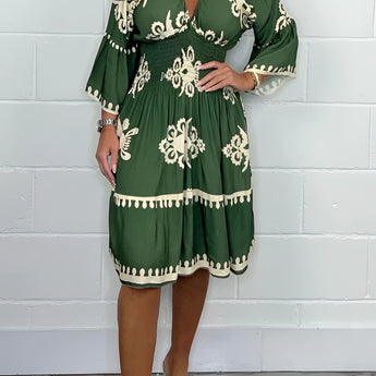 
A plus size dark green V-neck boho summer dress with floral embroidery, shown in size 3XL. The dress is a one-piece garment with short sleeves and falls to the knees.