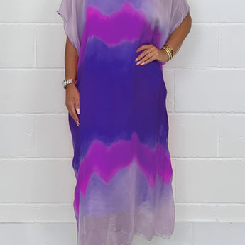Plus size tie-dye maxi kaftan in marina and violet colors, featuring batwing sleeves, worn as a beach cover-up.
