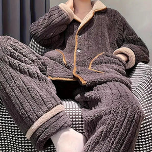 
A women's winter coat made from warm sherpa fleece, featuring a plush teddy bear texture. The grey jacket includes a wrap-style design with long sleeves and a wide collar, offering both style and comfort.