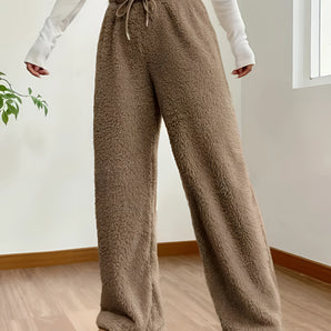 Women's plush teddy bear sweatpants in a cozy fleece material, designed for winter lounging. The image shows the sweatpants focusing on the waist and thigh areas, emphasizing comfort and warmth in a soft white color.