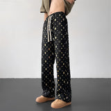 Retro photo print streetwear trousers featuring a vibrant Polaroid pattern, shown on a standing model. The pants highlight details such as the waist, thigh, and knee areas, capturing a unique and eye-catching style.