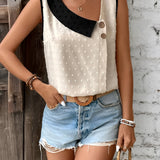 Women's chic fashion polka dot sleeveless summer blouse with contrast collar, featuring black and white design, shown on a model wearing black shorts.