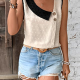 Women's chic fashion sleeveless summer blouse with polka dots and contrast collar in black and white.