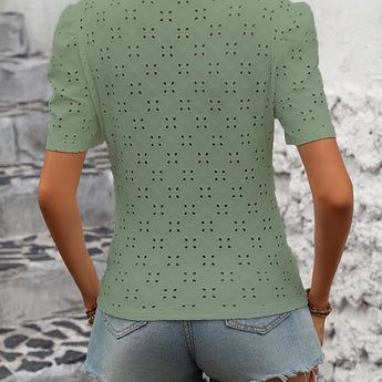 White polka dot blouse with short sleeves, featuring a trendy and casual chic design suitable for summer fashion.