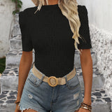 White polka dot blouse with short sleeves and a trendy, casual chic design.