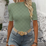 White Polka Dot Blouse with Short Sleeves, Featuring a Trendy Summer Casual Chic Fashion Design, Modeled on a Woman Wearing Sunglasses and Shorts