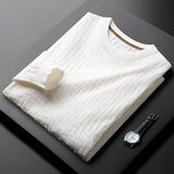 Premium men's blue sweater with braided texture and ribbed cuffs displayed on a wooden table.
