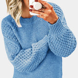 A light blue chunky cable knit sweater featuring long sleeves, a round neckline, and a cozy, oversized fit, designed for women in size 3XL. The texture and pattern are prominently displayed, highlighting the intricate knitwork.