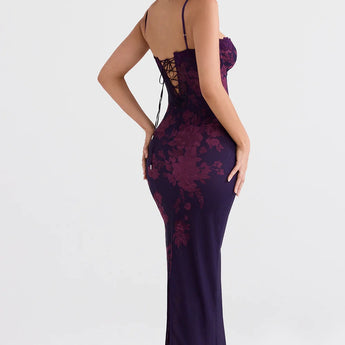 Purple floral lace backless corset evening gown with floor-length design, featuring elegant detailing around the shoulder and waist, worn by a model with black hair.