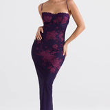 Purple floral lace backless corset evening gown, floor-length, worn by a model with long hair. The gown features a fitted sheath design with a strapless and sleeveless style, accentuating the waist, and showcasing an elegant and sophisticated look suitable for formal occasions.