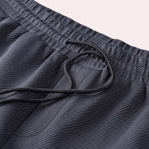 Grey quick-dry breathable gym shorts with an elastic waistband, designed for sportswear use.