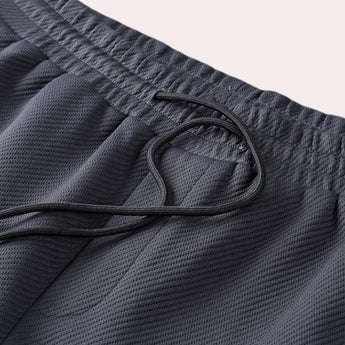 Grey quick-dry breathable gym shorts with an elastic waistband, designed for sportswear use.