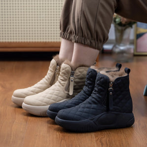 Quilted waterproof winter boots with cushioned sole for women, featuring an electric blue and carmine color scheme, shown on a hardwood floor.