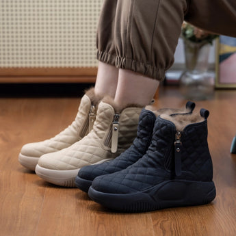 Quilted waterproof winter boots with cushioned sole for women, featuring an electric blue and carmine color scheme, shown on a hardwood floor.