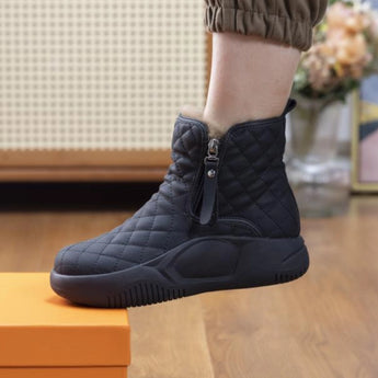 Black quilted waterproof winter boots with a cushioned sole for women, shown in size 42.