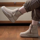 Quilted waterproof winter boots for women in grey and beige, featuring a cushioned sole and designed to keep feet warm and dry.