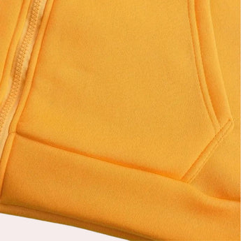 Men's streetwear hoodie with a color block design featuring red, black, and yellow. The hoodie includes long sleeves and is showcased on a wooden surface.