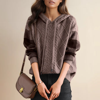 Red cable knit sweater with textured pullover design, featuring long sleeves and a round neckline.