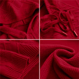 A red cable knit sweater with a luxurious textured design, showcasing intricate patterns and knitting style.