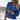 A woman wearing a blue cable knit sweater in a chunky textured design, suitable for fall fashion. The sweater features long sleeves and a high neckline, fitting comfortably on the person.