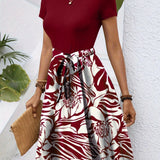 Red floral high-waisted A-line skirt worn by a woman, showcasing vibrant burgundian color, styled with a complementary top, accessorized with a watch and carrying a bag.