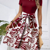High-waisted red floral A-line skirt designed for women's fashion, showcasing a vibrant pattern and elegant style.