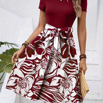High-waisted red floral A-line skirt designed for women's fashion, showcasing a vibrant pattern and elegant style.