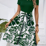 Red floral A-line skirt with a high waist, featuring vibrant floral patterns, styled as part of a fashionable day dress ensemble.