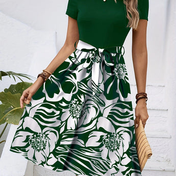 Red floral A-line skirt with a high waist, featuring vibrant floral patterns, styled as part of a fashionable day dress ensemble.