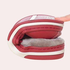 Red foldable slip-on sneakers, travel-friendly and lightweight, displayed against a simple background, highlighting their compact design and vibrant color.
