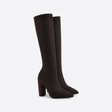Red knee-high sock boots with high heels made from ribbed fabric, featuring a fashion-forward design.