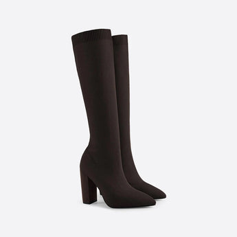 Red knee-high sock boots with high heels made from ribbed fabric, featuring a fashion-forward design.