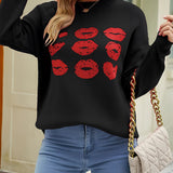 
A chic black pullover sweater featuring a bold red lip print design, worn by a model. The sweater is styled with eyewear and showcases a comfortable fit with visible shoulder and arm details.