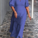 Blue maxi dress featuring puff sleeves, a square neckline, and studded pockets, worn by a person smiling.