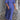 Blue maxi dress featuring puff sleeves, a square neckline, and studded pockets, worn by a person smiling.