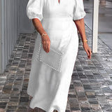 
A woman wearing a white one-piece maxi dress with puff sleeves and a square neck, featuring studded pockets, standing and smiling.