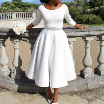 White long sleeve boat neck A-Line midi dress with pockets in size 2XL, modeled by a woman standing.