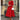Woman wearing a red midi dress with long sleeves, a boat neck, A-line silhouette, and pockets, standing and showcasing the fit around the waist, size 2XL.