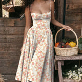 Red midi dress with spaghetti straps in a vintage-style tea dress design, shown in pink, size XL, displayed outdoors with greenery in the background.