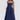 Blue midi dress with spaghetti straps, vintage-style design featuring a fitted waist and flowing skirt, modeled by a woman with long hair, highlighting the dress's elegant and classic tea dress silhouette.
