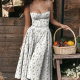 Green midi dress with spaghetti straps, vintage-style tea dress design, displayed on a mannequin against a plain background.