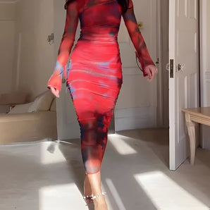 Red multi-color abstract print bodycon midi dress with asymmetric neckline, featuring long sleeves and a fitted waist design.