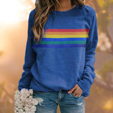 Red multicolor striped crewneck sweatshirt paired with blue jeans, showcasing casual autumn fashion.