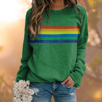 Red multicolor striped crewneck sweatshirt worn by person paired with jeans, showcasing casual autumn fashion.