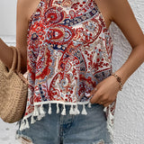 Red paisley halter top featuring tassel trim, styled for a boho summer festival look, worn by a person with white shorts.