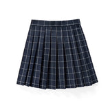 Red plaid pleated tartan skirt styled in a preppy schoolgirl fashion, displayed on a table.