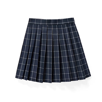 Red plaid pleated tartan skirt styled in a preppy schoolgirl fashion, displayed on a table.
