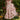 Vintage style red rose print fit and flare dress designed for garden parties, featuring a one-piece garment with a flattering waist, short sleeves, and a round neckline, set against a backdrop of lush grass.